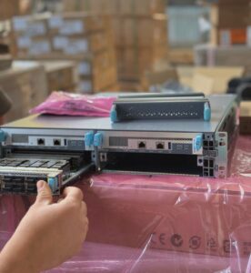 ITcare engineer installing a line card into a Juniper MX304 chassis during preconfiguration